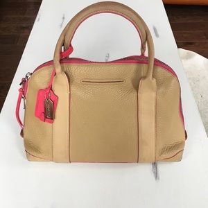 Cute and authentic tan Coach bag with pink accents